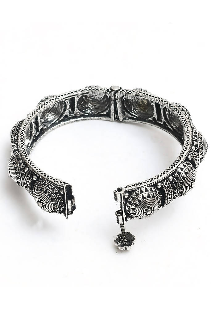 Close-up of a handcrafted oxidised silver-plated bracelet with intricate design patterns