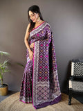 Elegant purple Lichi soft silk Banarasi saree with intricate jacquard woven patterns and a matching solid blouse.