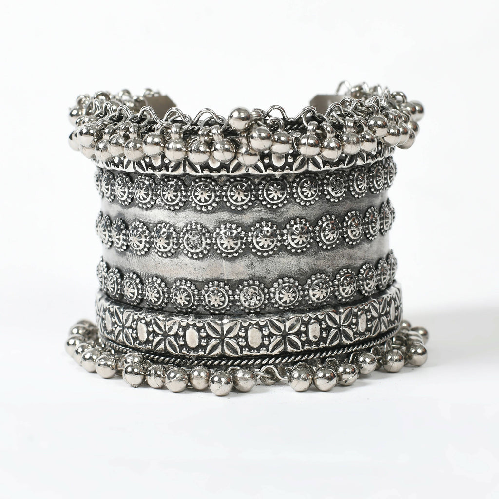 Close up of an intricate Joharkamal Oxidised Silver-Plated Ghungroo bracelet on a model's wrist