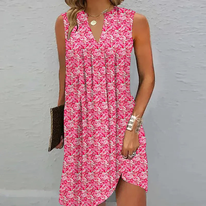 A woman wearing a vibrant pink floral A-line sleeveless dress with a v-neckline.