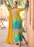 Woman wearing a yellow premium Chinon palazzo suit with heavy embroidery and hand-work detail.
