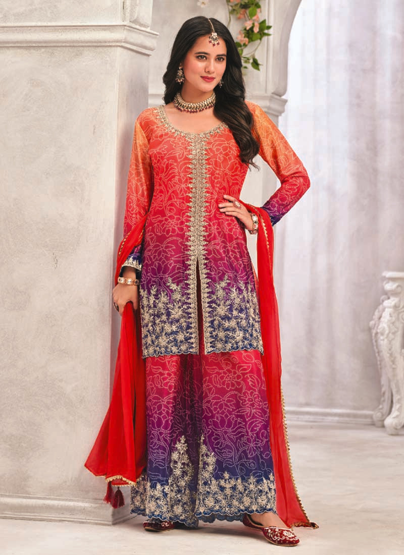 Model wearing a vibrant red premium Chinon palazzo suit with heavy hand-worked embroidery.