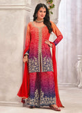 Model wearing a vibrant red premium Chinon palazzo suit with heavy hand-worked embroidery.