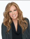 A woman wearing a sleek, long layered modern wig in RL2/4 Off Black.
