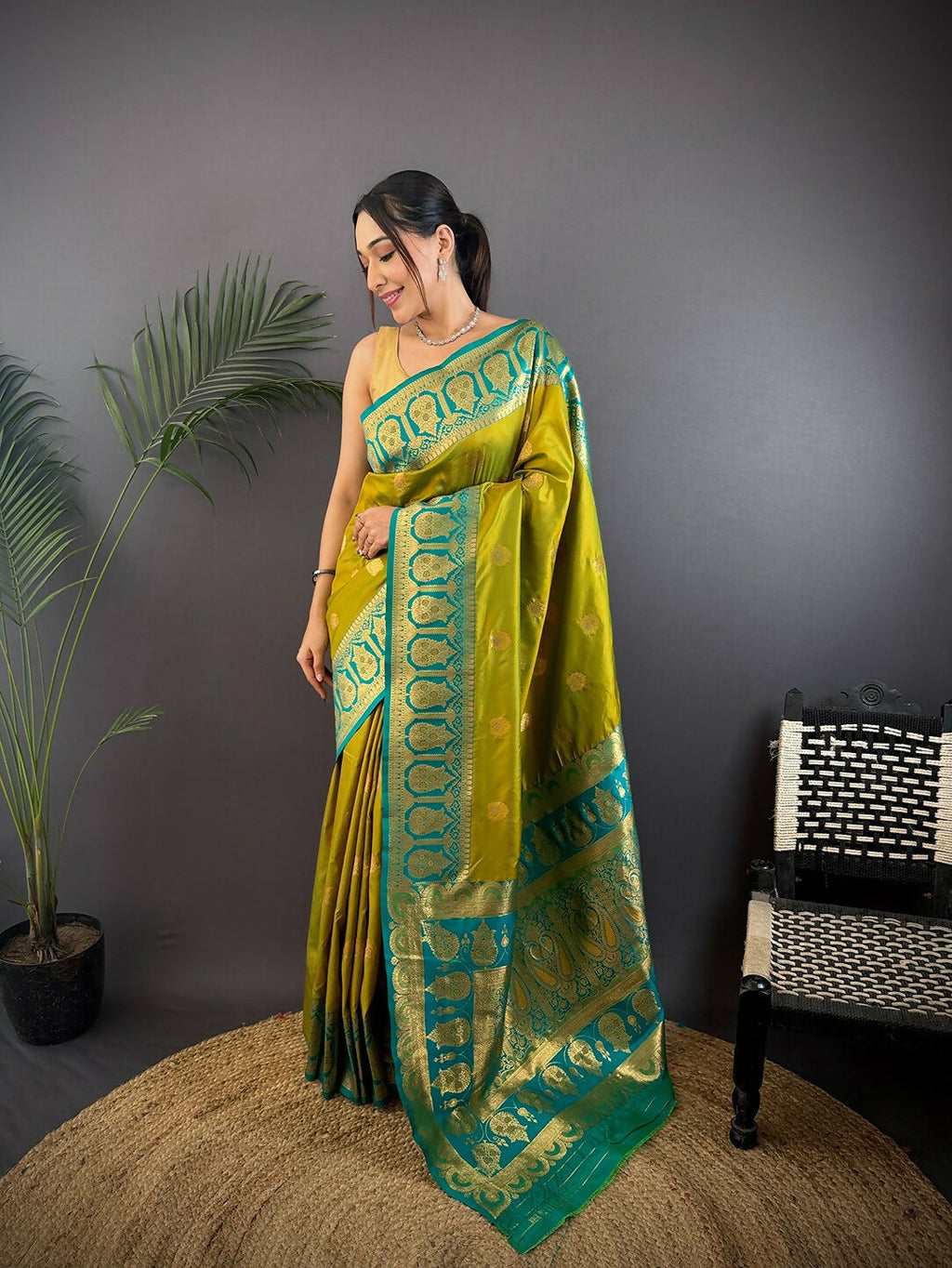 Teal-colored soft silk Banarasi saree with intricate butti design and unstitched blouse piece