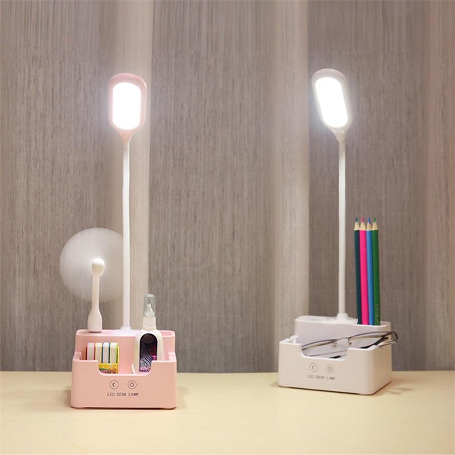 Pink and white multifunctional LED desk lamp with built-in fan and phone holder.