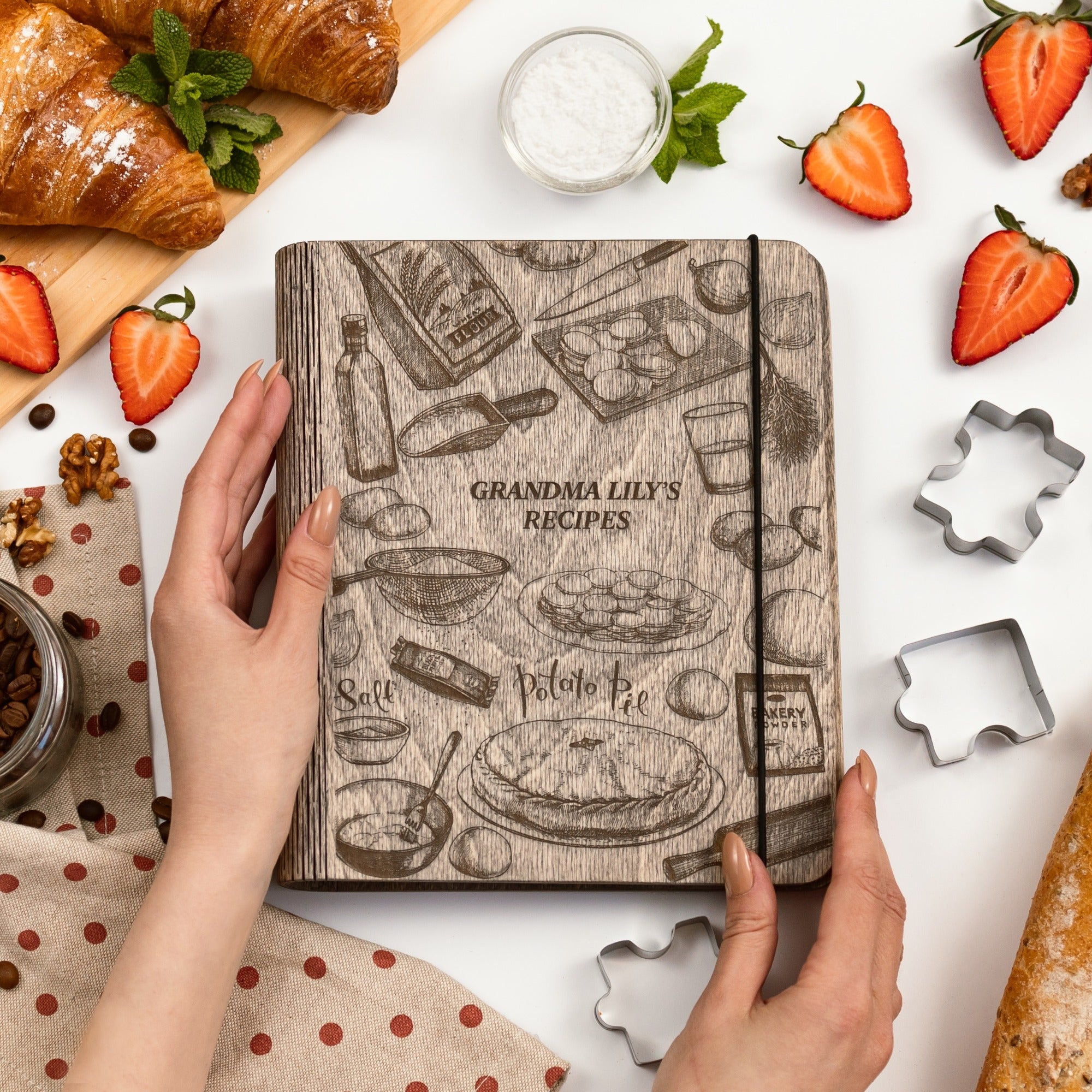 Close up of an elegant wood-covered Recipe Book for Potato Pie on a kitchen counter.