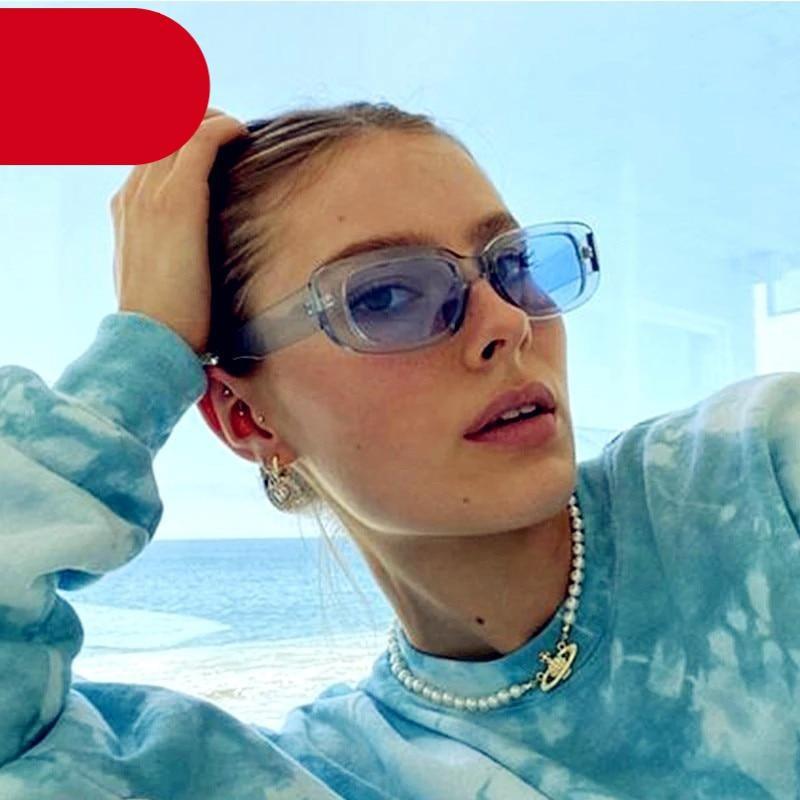 A pair of thick-frame retro rectangle sunglasses for men and women on a neutral background.