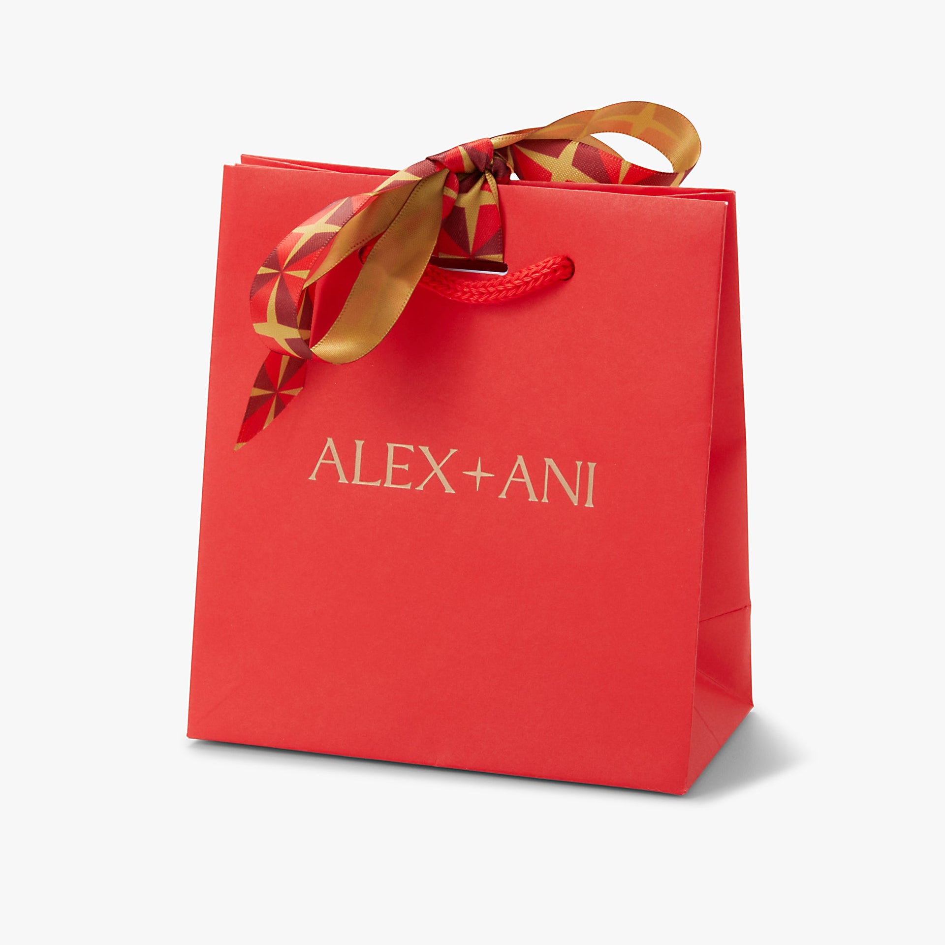 A vibrant red gift bag decorated with a luxurious red and gold ribbon bow.