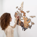 3D wooden map of Canada in multicolor finish, featuring provincial markers.