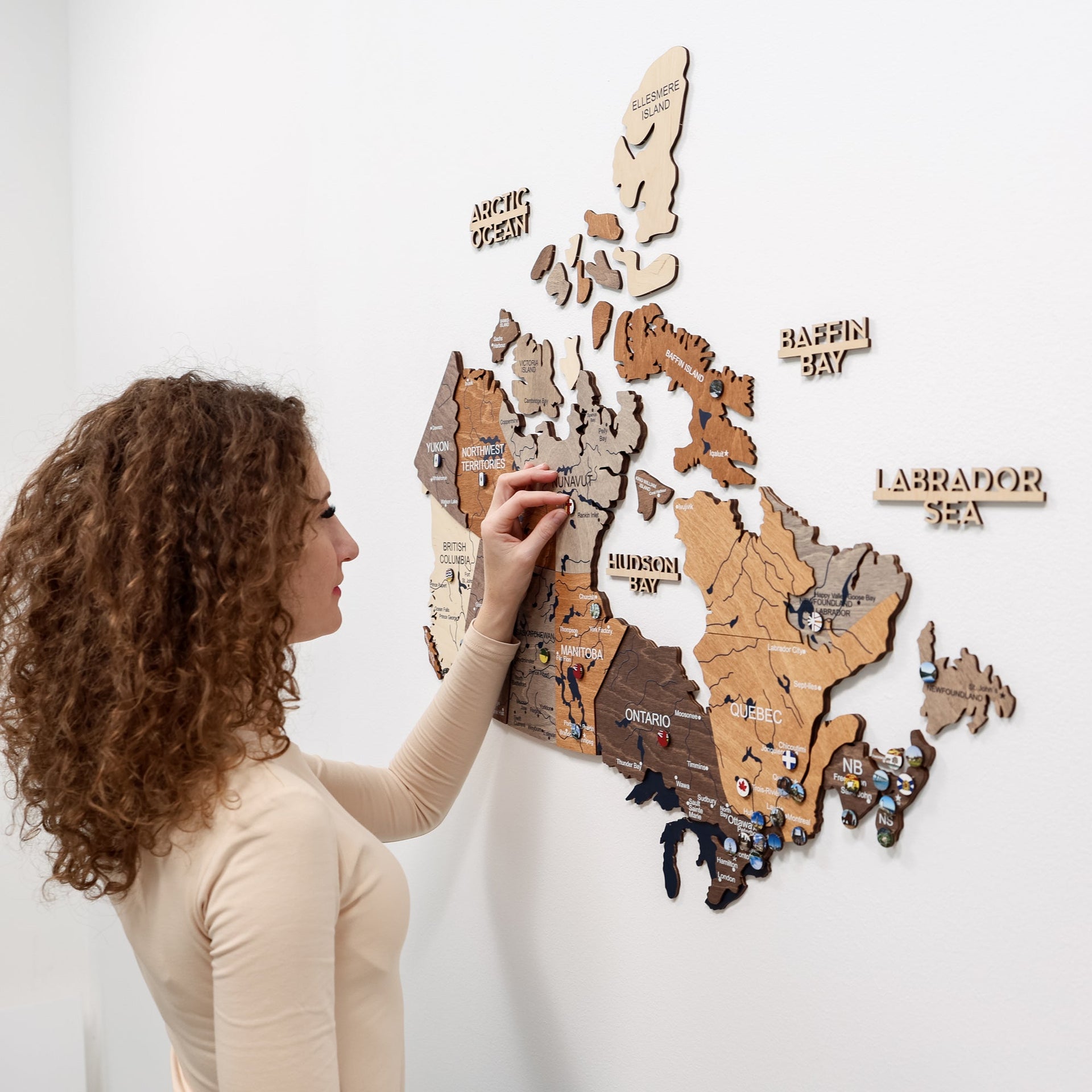 3D wooden map of Canada in multicolor finish, featuring provincial markers.