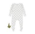 A baby's ribbed white romper with a small green leaf print, displayed flat with a single fern leaf beside it.