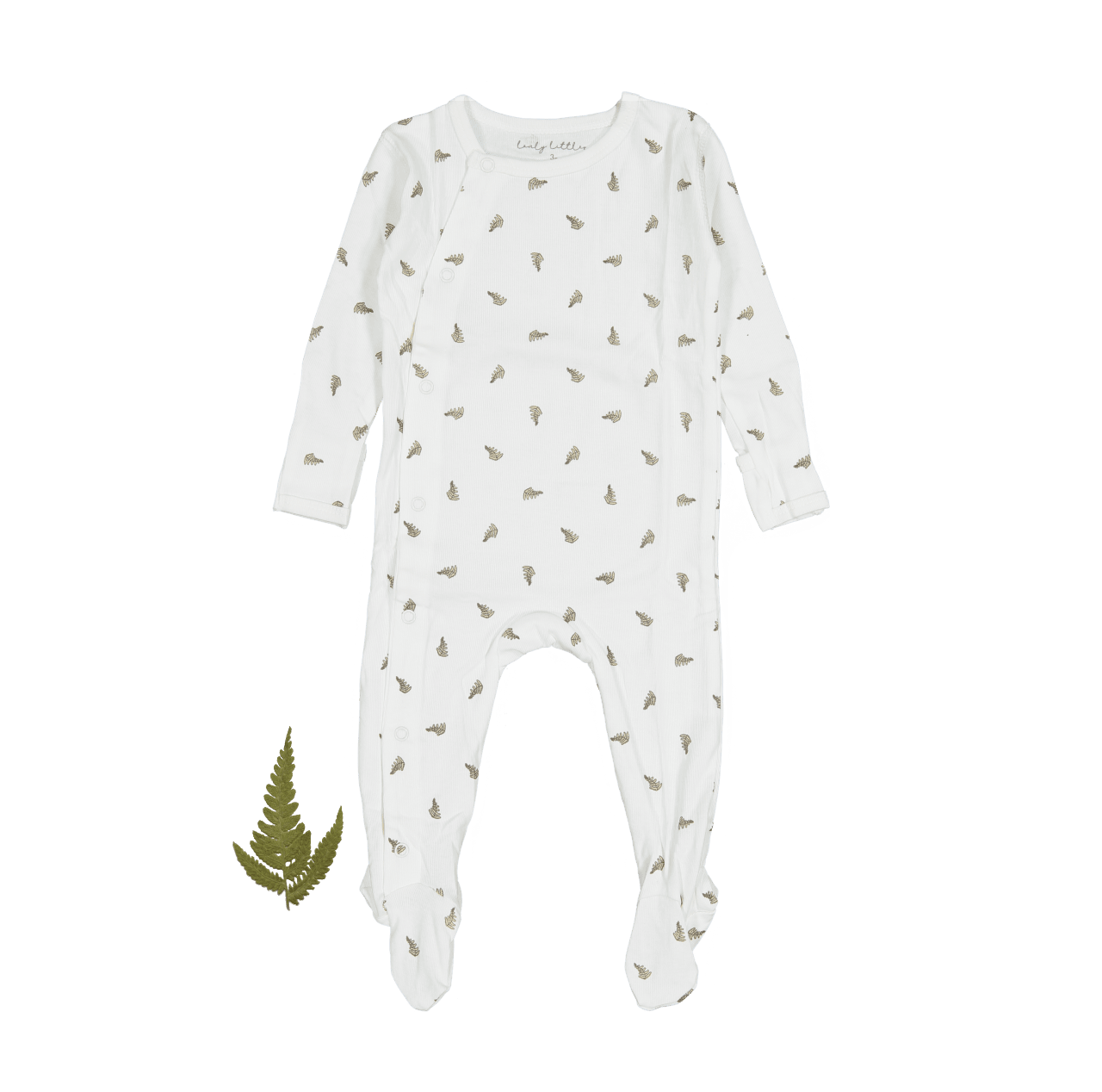 A baby's ribbed white romper with a small green leaf print, displayed flat with a single fern leaf beside it.