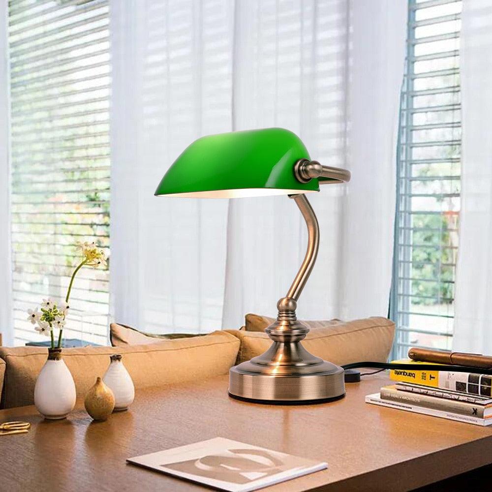 Vintage bronze and green Bankers desk lamp on an office study table.
