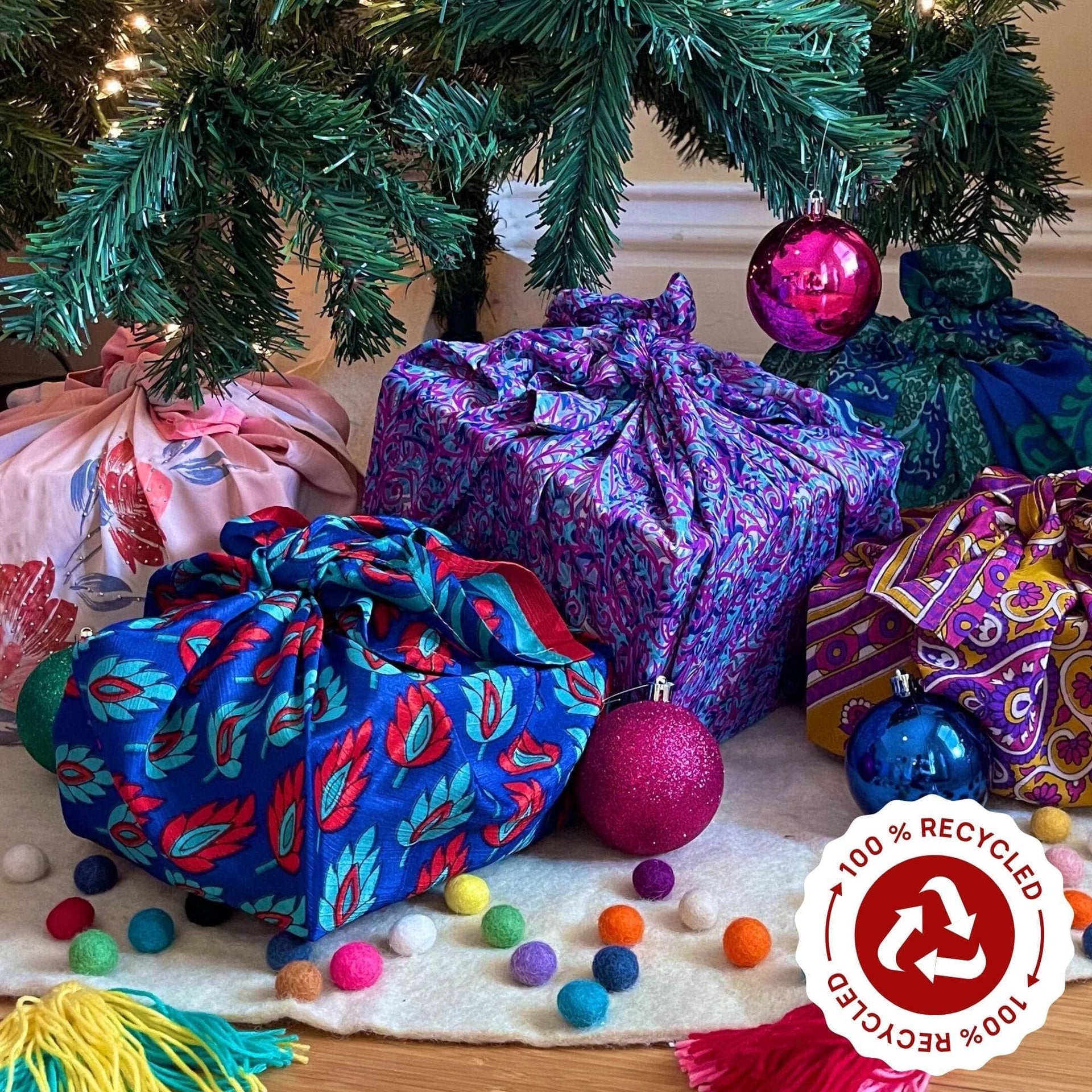 Five vibrant, abstract patterned sari silk fabric squares in shades of magenta, yellow, green, and blue for reusable gift wrapping.