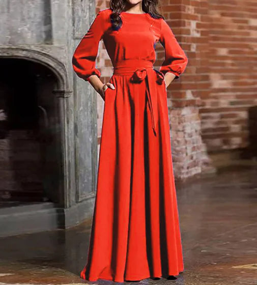 A woman wearing a solid color long-sleeved maxi dress with a round neck and a tie waist detail, available in red, yellow, and black.