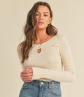 Ivory ribbed sweater with a stylish cut-out neckline detail.