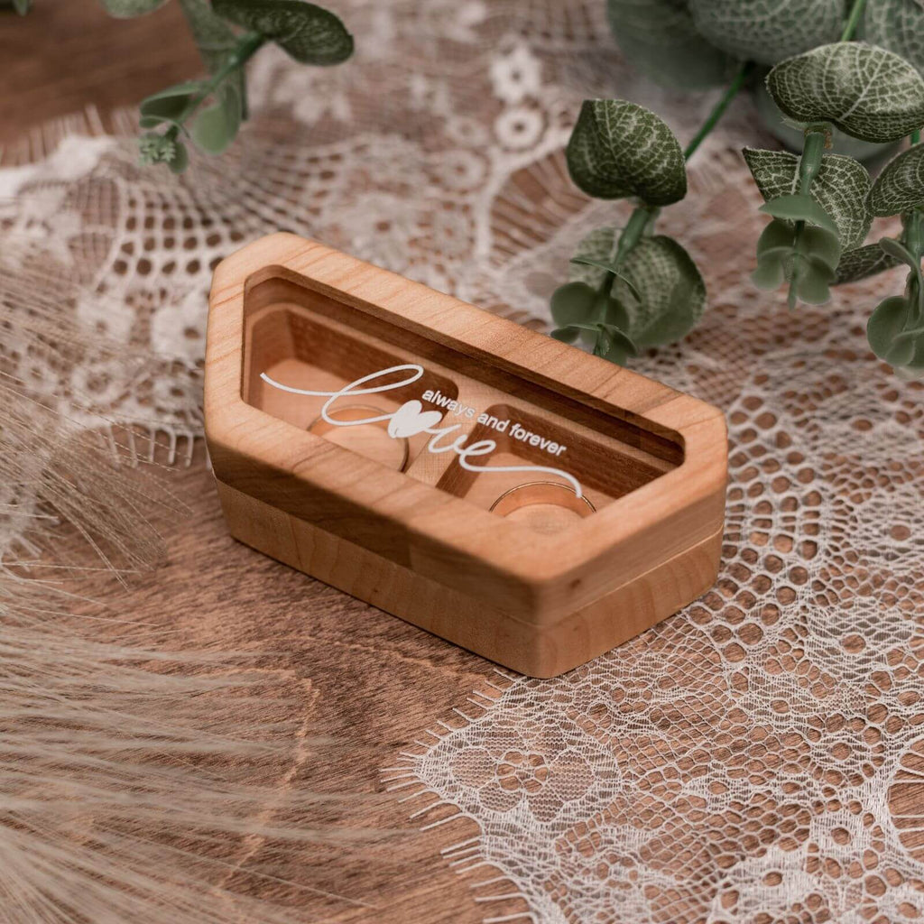 Close up of a handcrafted alder wood wedding ring box with a clear acrylic lid