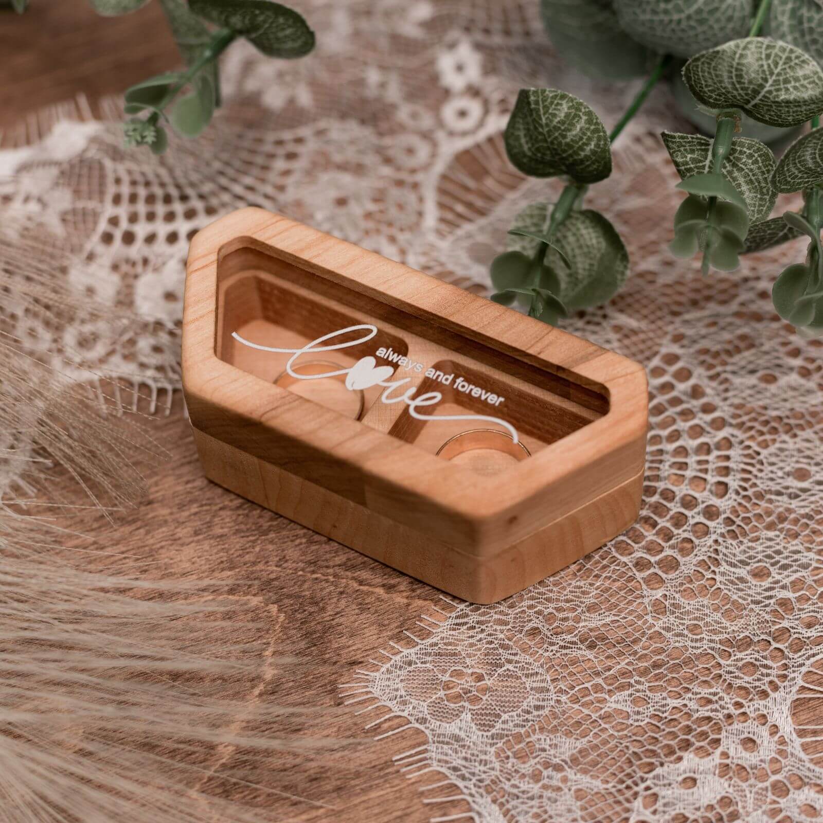 Close up of a handcrafted alder wood wedding ring box with a clear acrylic lid