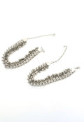 Close up of heavy oxidised silver traditional anklets featuring intricate ethnic patterns