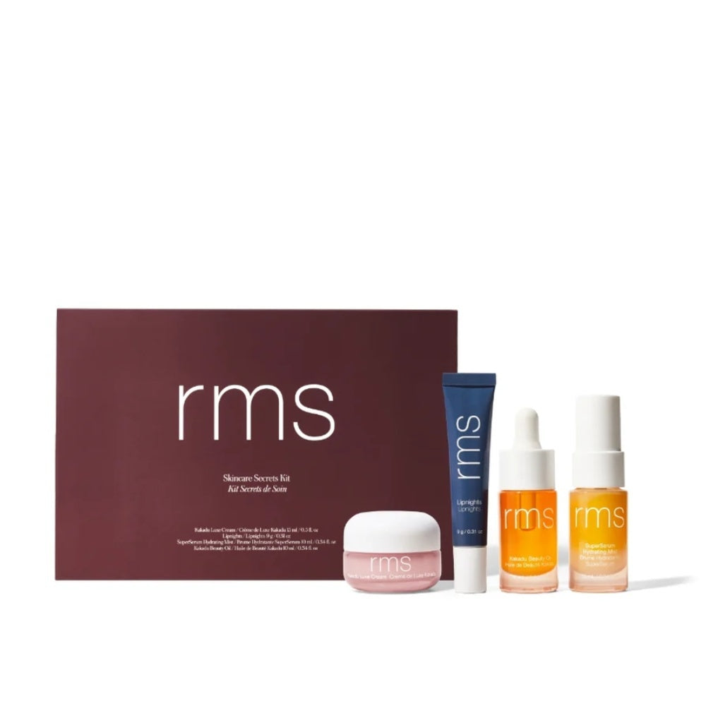 RMS Beauty Skincare Secrets travel kit featuring creams, facial oil, serum mist, and lip treatment in minimal packaging.