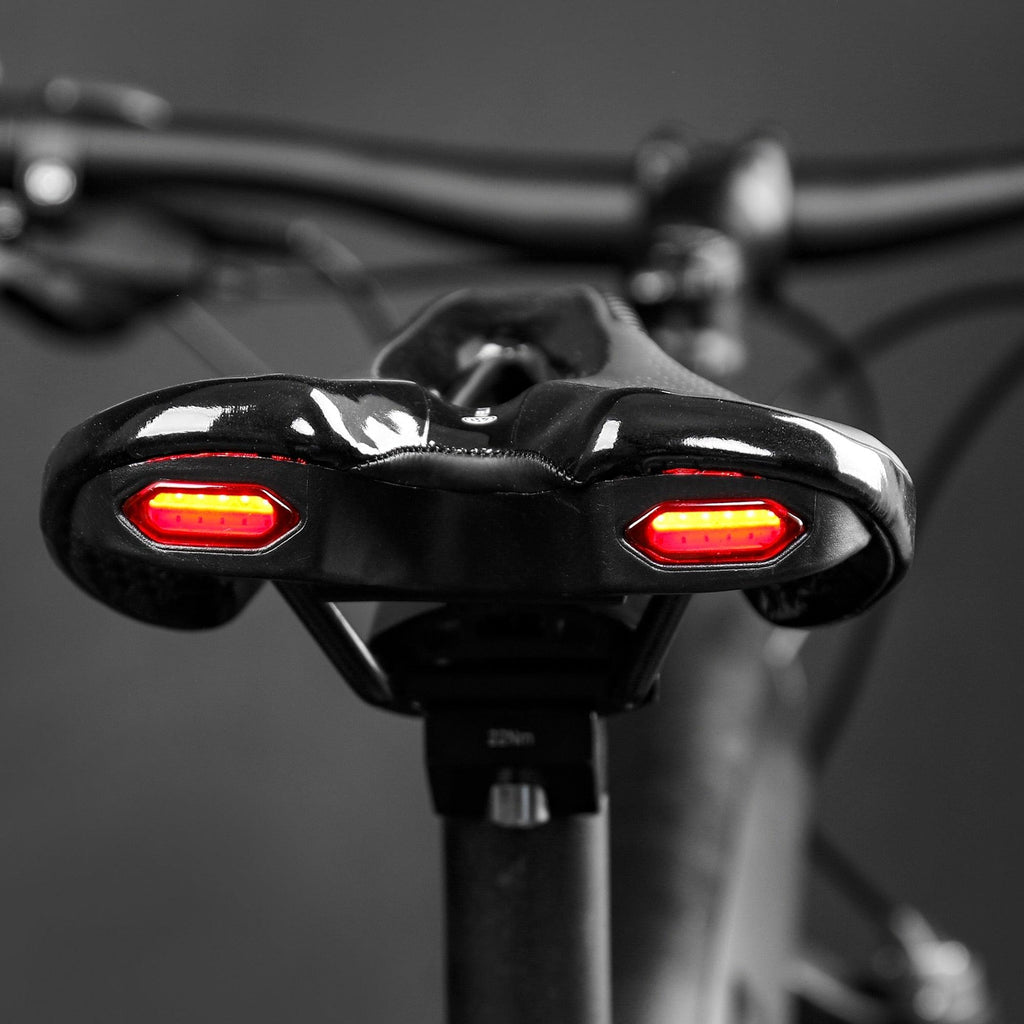 Sporty bike saddle in black and red with integrated rear safety light