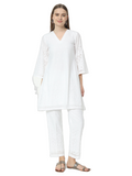A white co-ord set with intricate Chikankari embroidery, featuring a V-neckline and bell sleeves.