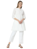 Woman wearing a stylish white Chikankari co-ord set with a round cut neck