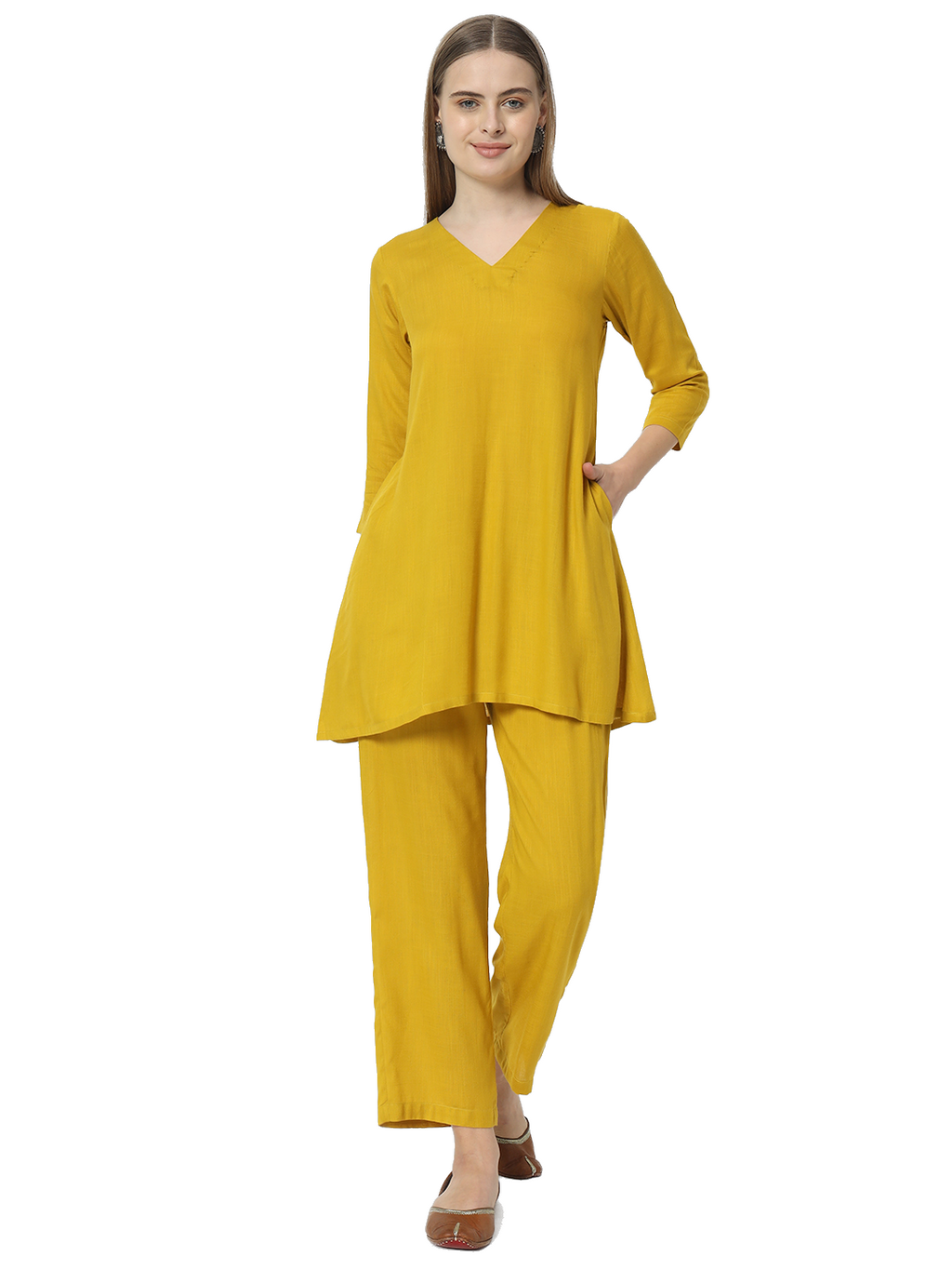 Woman wearing a mustard yellow pure cotton co-ord set with v-neck and three-quarter sleeves in a minimalist style