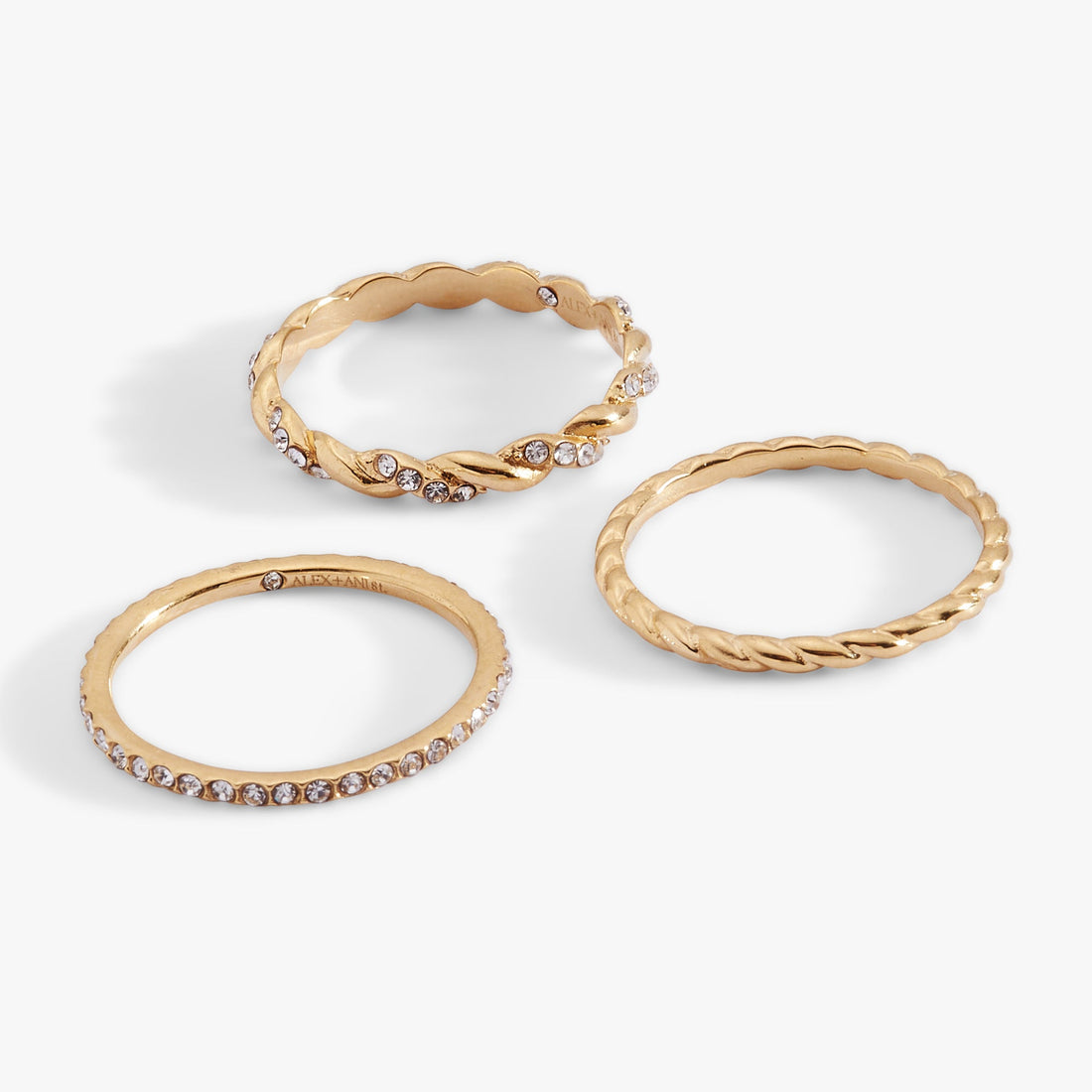 Set of three thin stackable rings featuring rope textures and crystal pavé in gold and silver tones.