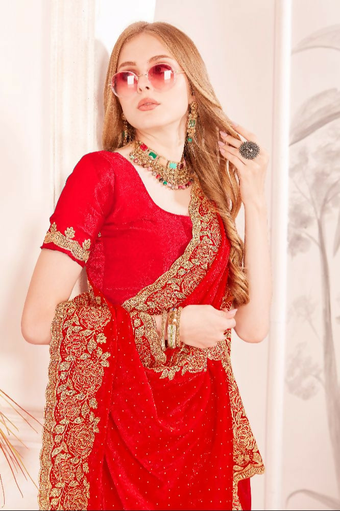 Close up of red silk saree with heavy zari, resham, and zircon embroidery work.
