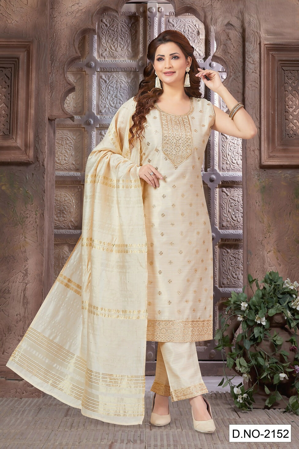 Model wearing an off white tissue fabric kurta set with decorative embroidery
