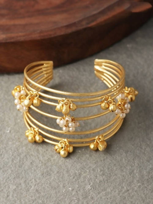 A beautiful matt golden ghungroo bracelet for women with a bohemian and traditional Indian design.