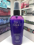 Bottle of TIGI Bed Head Dumb Blonde Toning Protection Spray for neutralizing brassy tones.