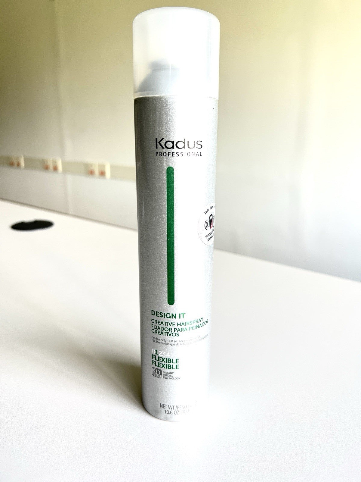 Kadus Professional Design It Creative Hairspray in a 10.6 oz silver and green can.