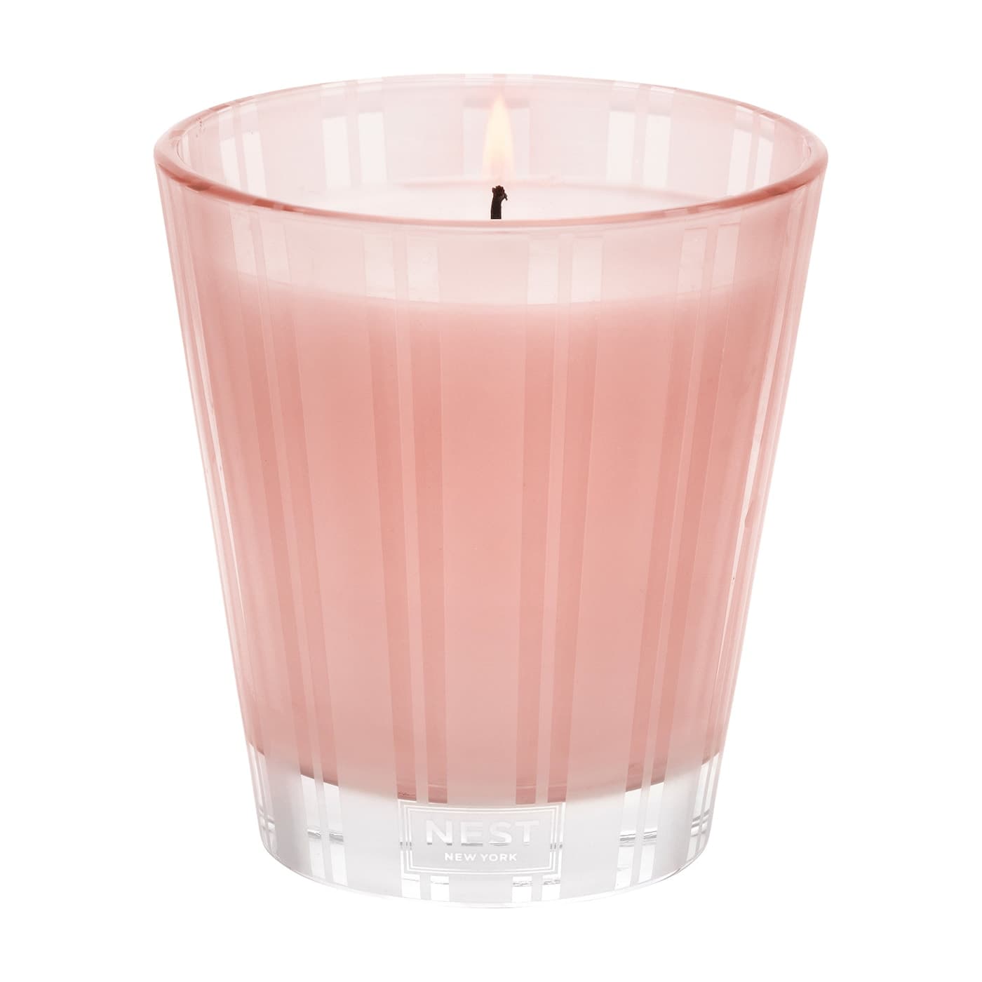 Modern striped pink and clear glass Nest New York Himalayan Salt & Rosewater candle on a minimalist surface