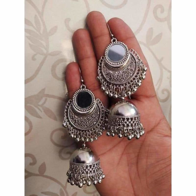 A pair of elegant artificial silver fashion earrings for women displayed on a neutral background.