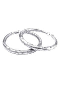 Close-up of oxidised silver pressing style anklet with traditional patterns