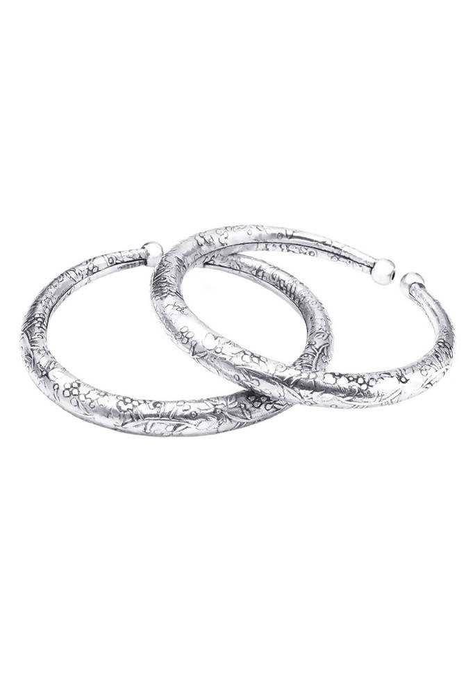 Close-up of oxidised silver pressing style anklet with traditional patterns