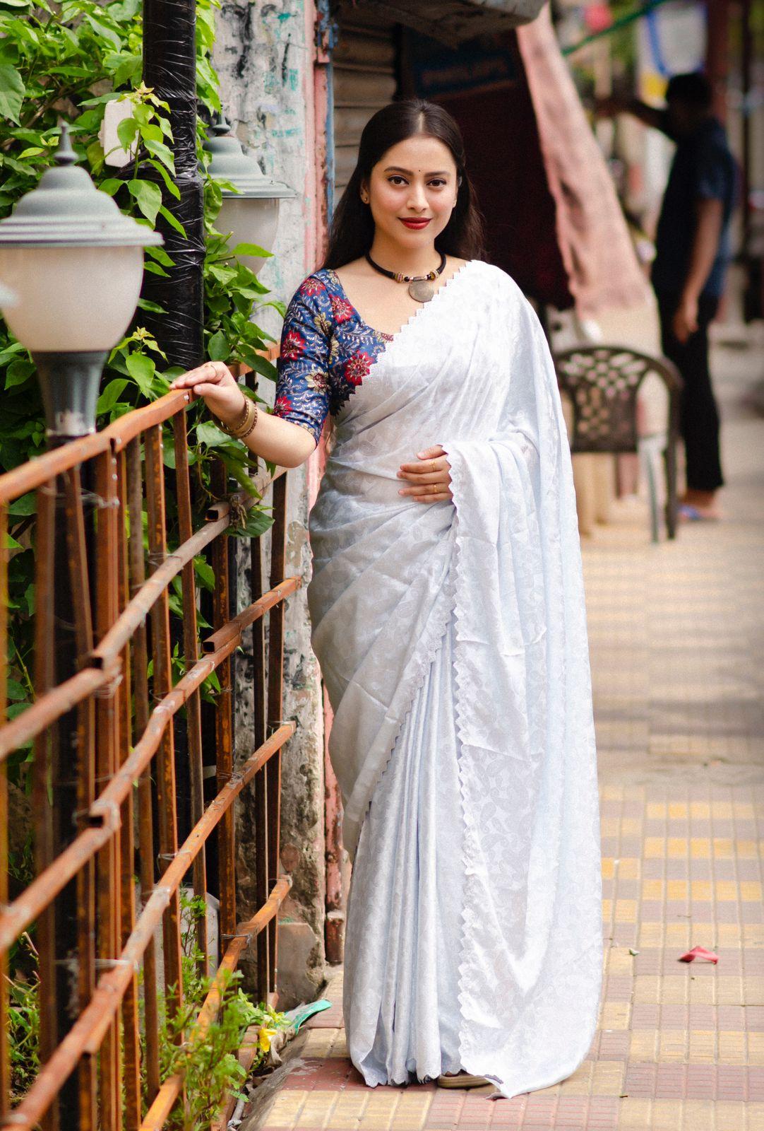 White poly silk saree with ethnic mango motifs and fancy cutwork border