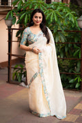Blue pure linen saree featuring intricate mirror work and a decorative temple border.