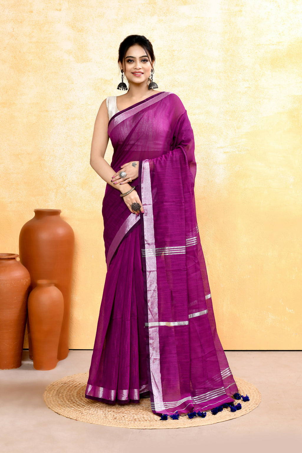 Magenta cotton blend handloom saree featuring an ornate zari border and embellishments