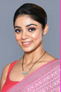 A golden white American Diamond mangalsutra with intricate bead detailing on a display stand.