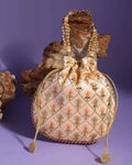 Peach colored Joban Fashion embellished potli bag with intricate detail for festive occasions