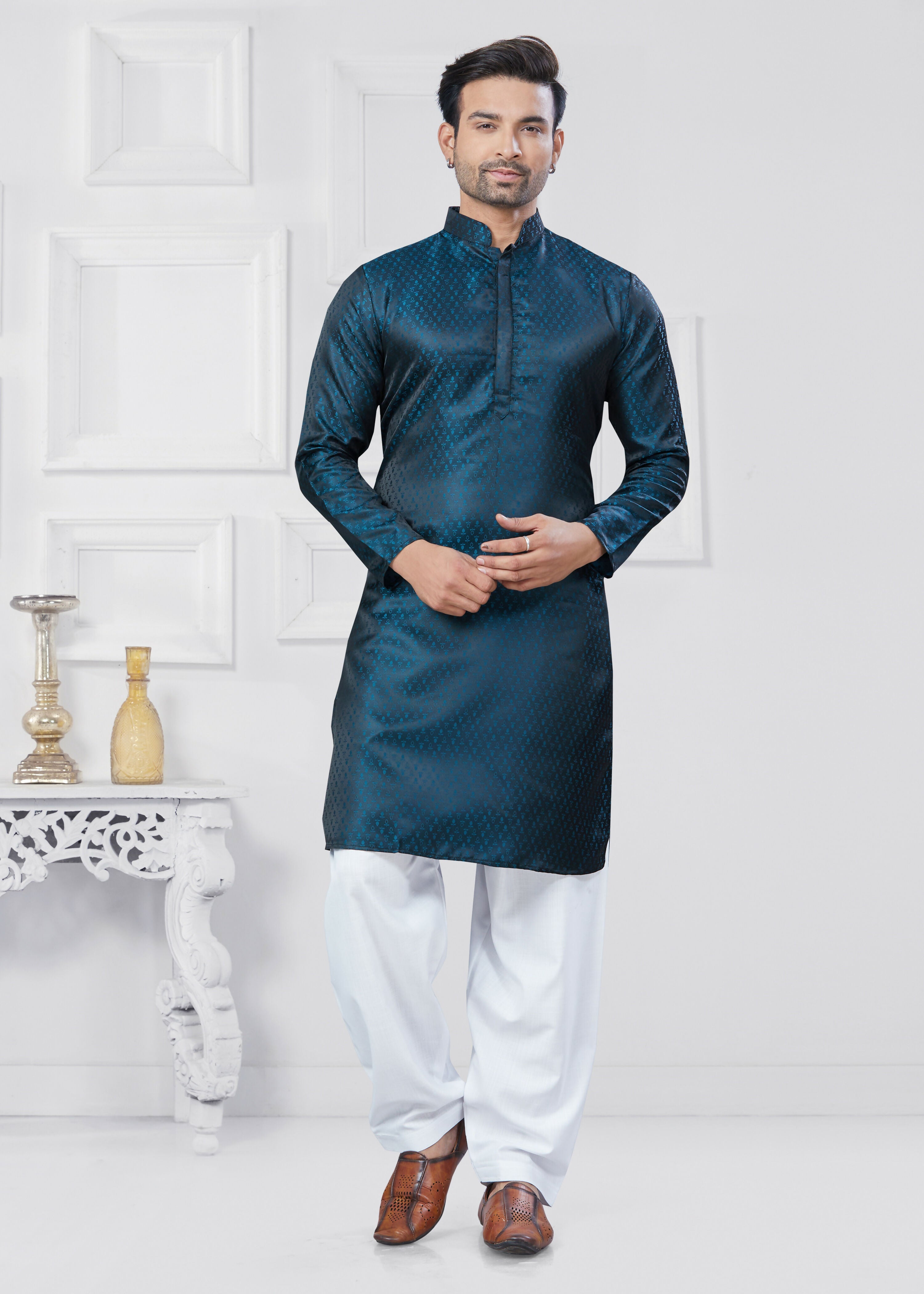 A man wearing a Rama colored Jacquard Silk printed kurta pyjama set with detailed patterns.