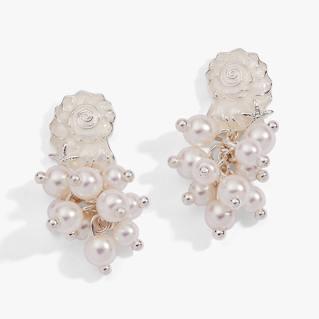 Coastal-inspired statement earrings featuring white pearl drops, a silver starfish accent, and a seashell top.