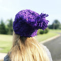 Vibrant purple handmade crochet beanie with a relaxed fit and bohemian aesthetic