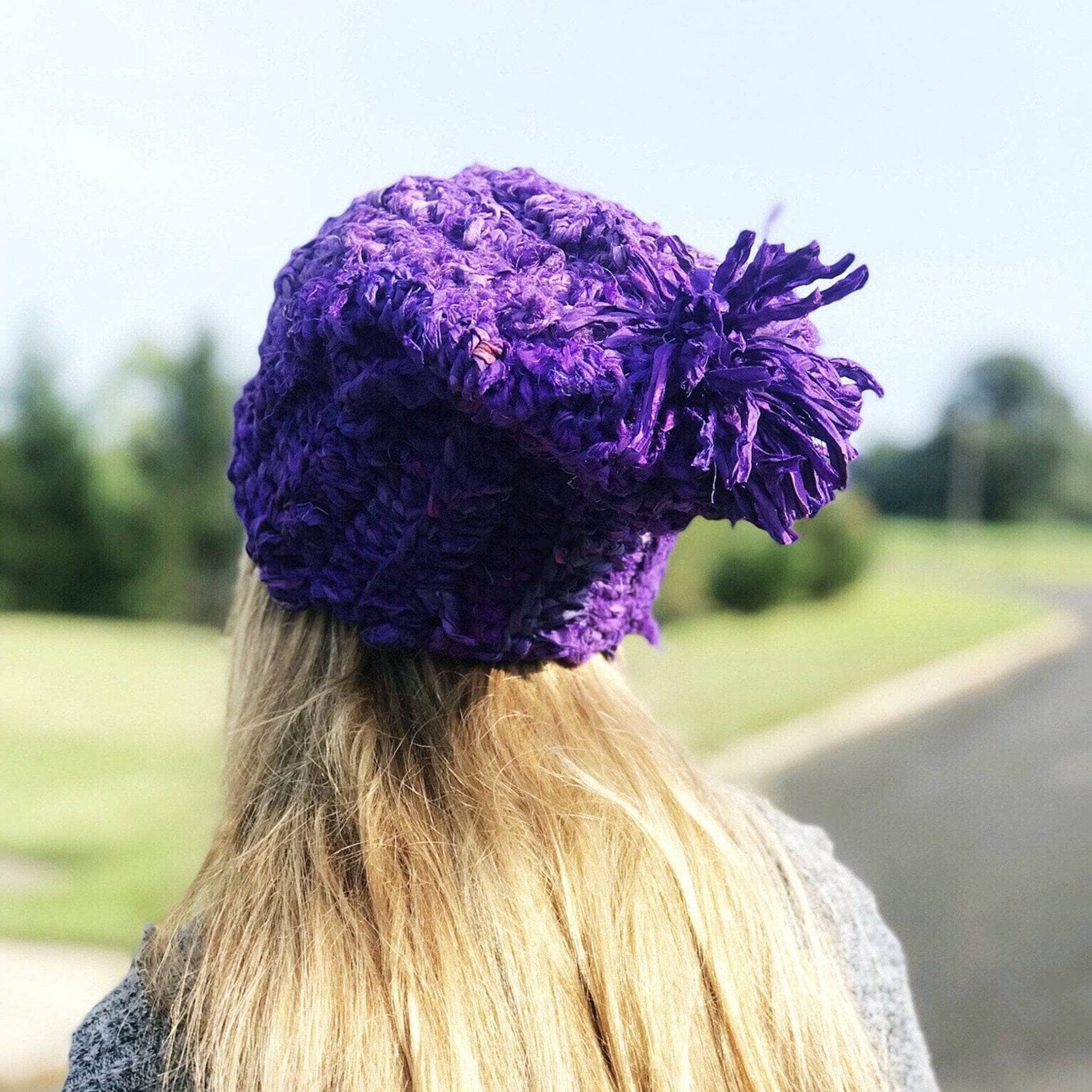 Vibrant purple handmade crochet beanie with a relaxed fit and bohemian aesthetic