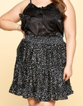Close up of a Satin Tiered Mini Skirt featuring a lustrous finish and tiered silhouette.