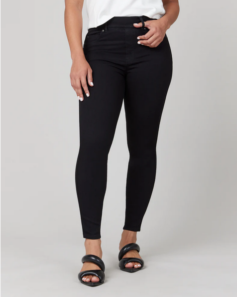Model wearing Clean Black high-rise skinny jeans with a pull-on waistband and stretch denim fabric.